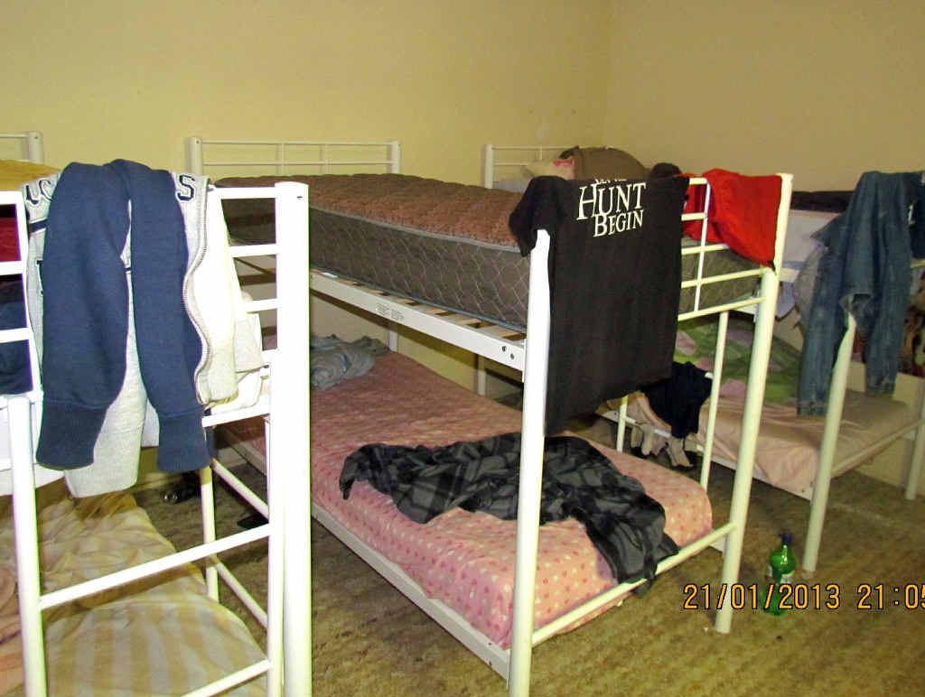 RACK AND STACK (Above and bottom right): Bunking down in one of the dodgy sites inspected by the council and the QFRS. (Top right): Shoes and boots off please, and get ready for the big squeeze.